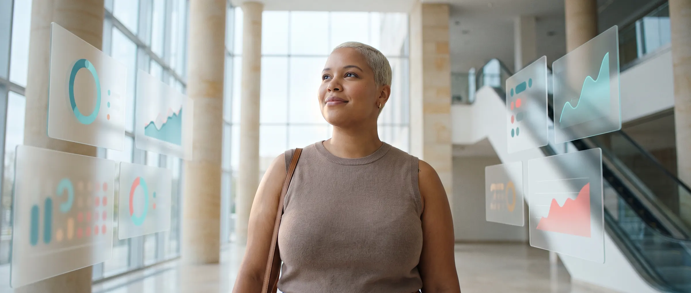 A woman walking through a bright atrium, her health data floating around her